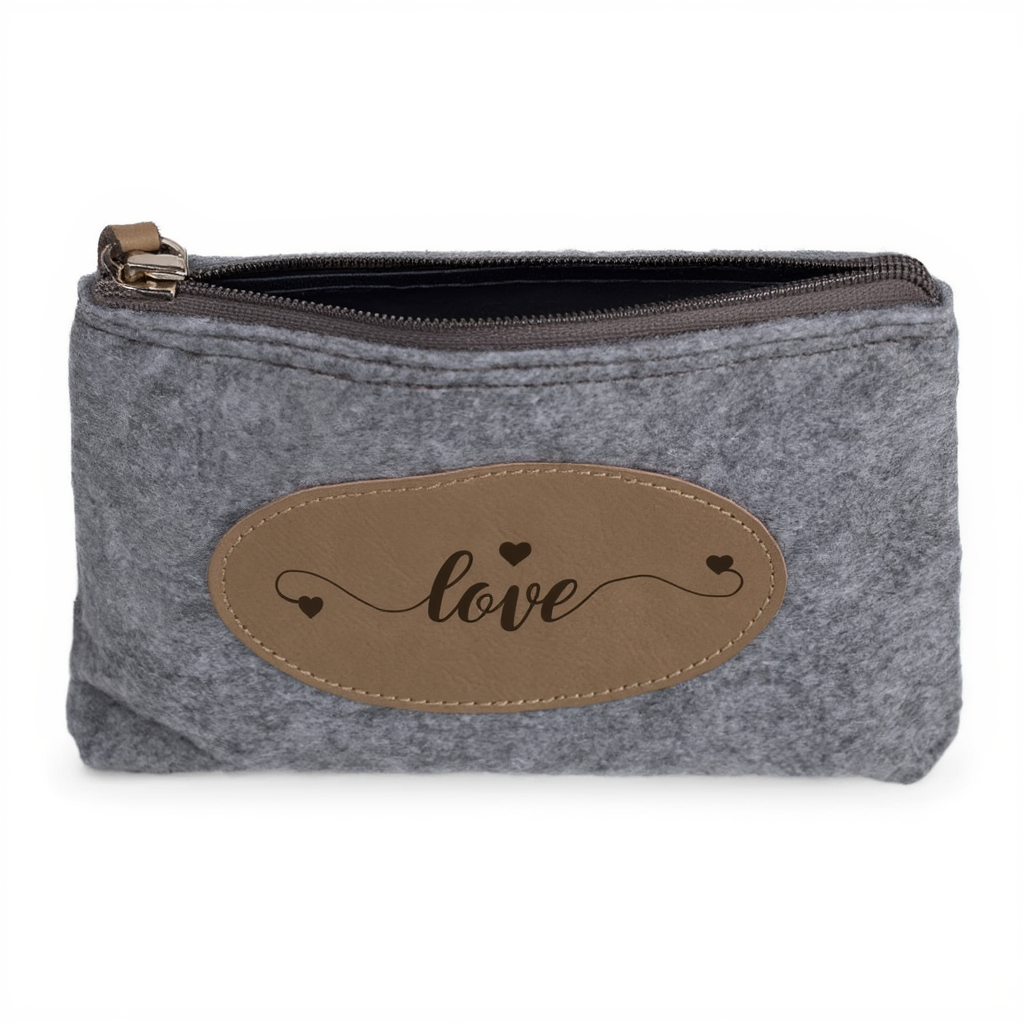Gray pouch with a brown leather patch displaying the word 'love' on a white background
