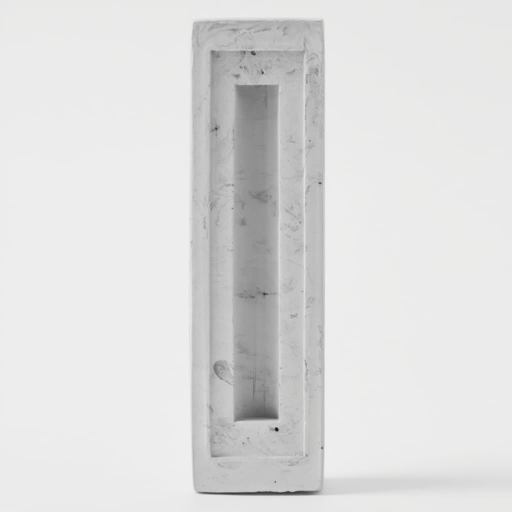 Rectangular concrete block with a narrow opening on a white background